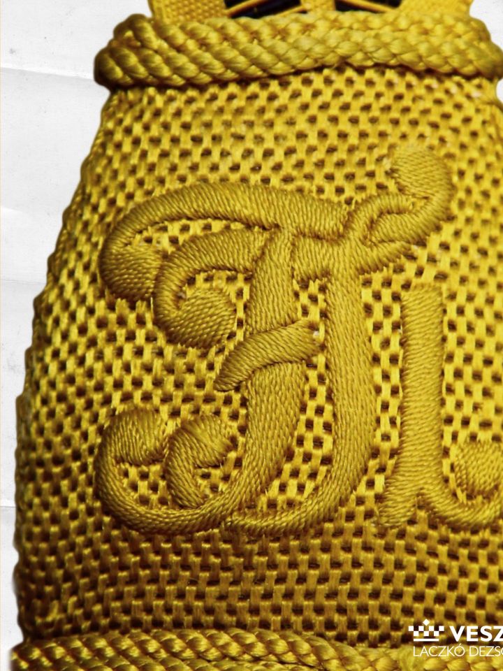 Az előző szolgálati öv gombja I. Ferenc József császár-király névbetűivel